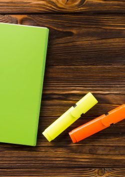 marker-pens-near-closed-notepad